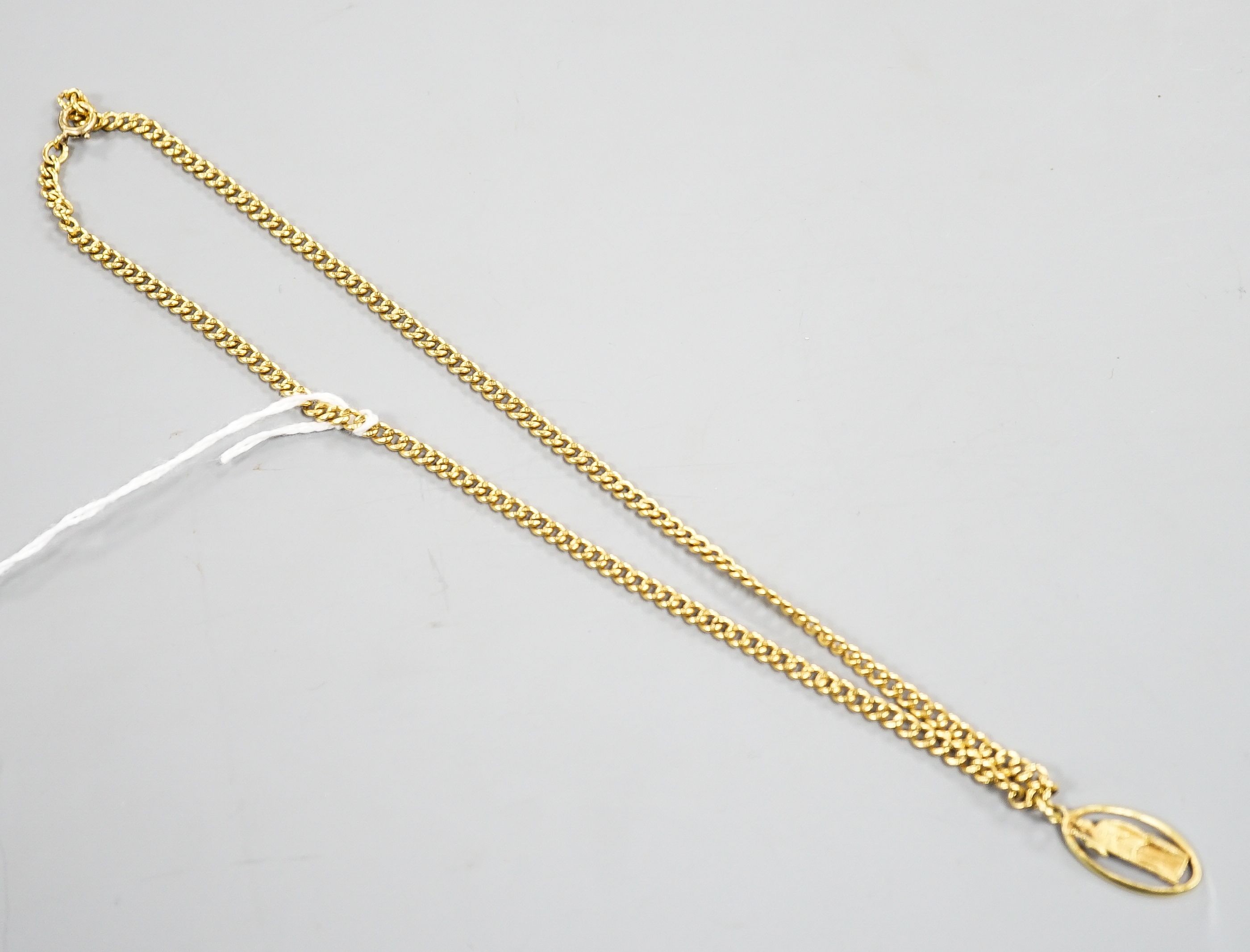 A 9ct curb link chain, 44cm, 15.7 grams, with a yellow metal St. Christopher pendant, engraved '18', 2.5 grams.